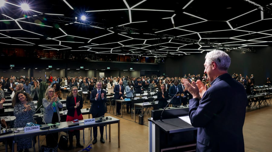 UN High Commissioner for Refugees, Filippo Grandi, stands and applauds during the closing session of the Global Refugee Forum. 