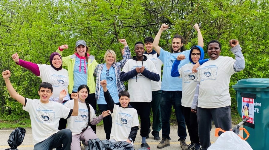 Participants of REACH, Refugee Education and Adventure Challenge, take part in a Chicago River Day cleanup in the West Ridge community. © REACH