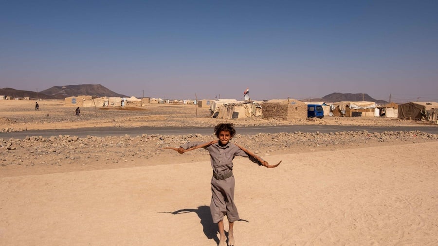 Yemen. A boy plays at a site for internally displaced people