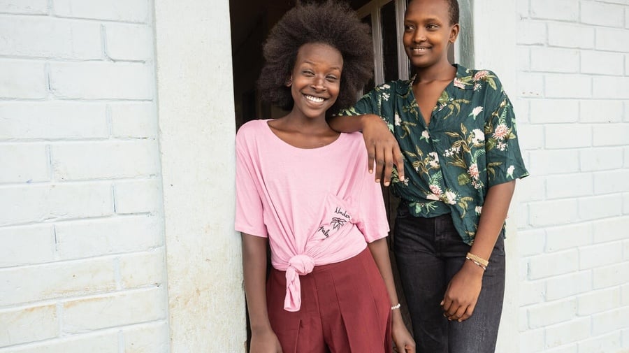 Two smiling sisters wearing clothing donated by Inditex