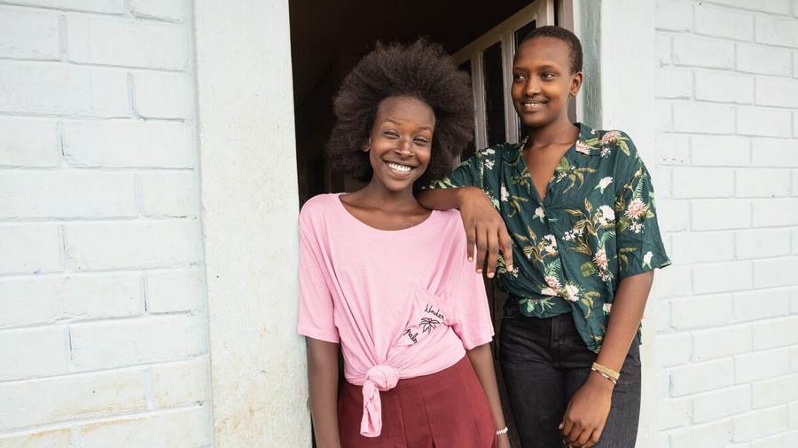 Two smiling sisters wearing clothing donated by Inditex