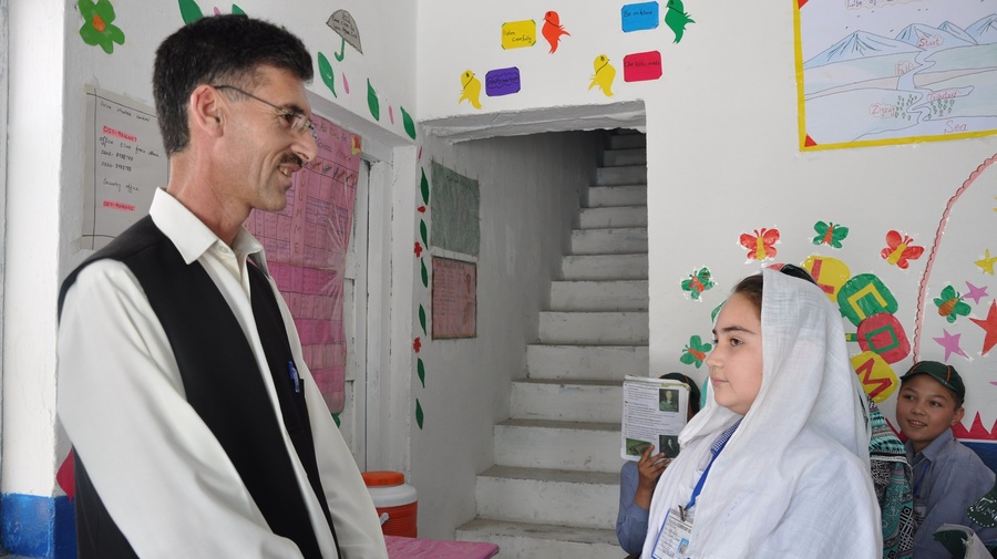 Abdur Rehman talking to a student in one of his schools in Attock.