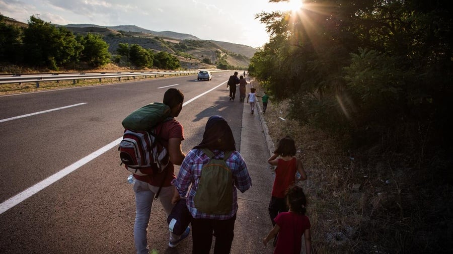 Macedonia. Syrian refugees walk main highway