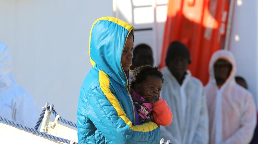 Italy. Migrants and refugees aboard the Italian Coast Guard vessel 'Corsi' arriving at the port of Augusta