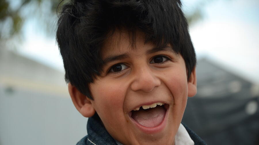 Afghan boy Farzad that stopped talking after separation from his mother, playing in Karatepe site