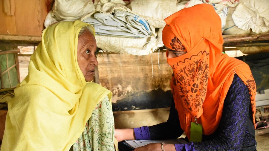 A community health worker counsels a 70-year-old Rohingya refugee.