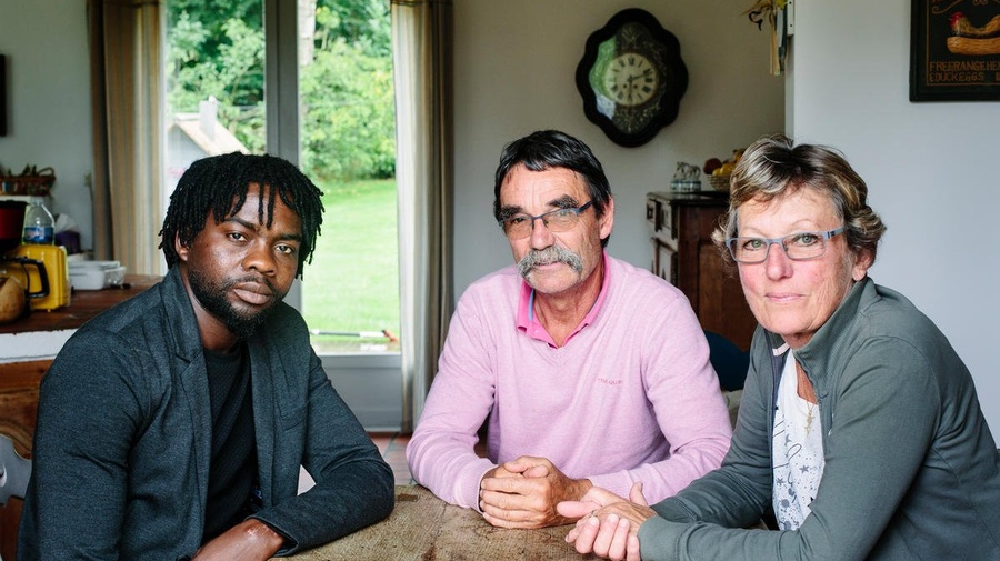 France. Catherine and Jean-Pierre host Assadik, a refugee from Sudan, in Saint-Josse. This portrait is part of the No Stranger Place series, which portrays locals and refugees living together