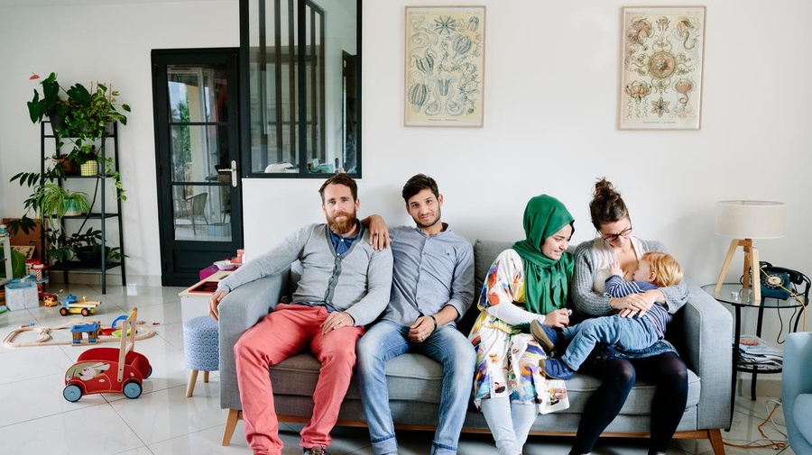 France. Anaïs, Vincent, and their son César, host Afghan refugees Zulfeqar and Battarine, in Saint-Priest. This portrait is part of the No Stranger Place series, which portrays locals and refugees living together