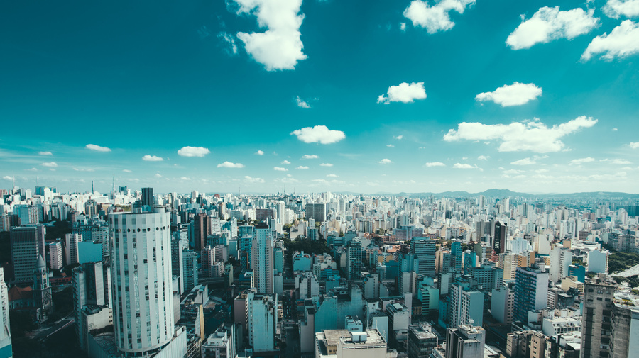 Wide shot of buildings in Sao Paulo, Brazil, with blue sky and clouds overhead