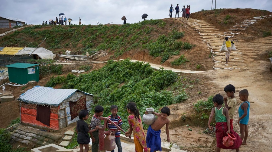 Bangladesh. Rohingya refugees fill containers at a water well in Kutupalong settlement