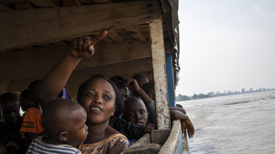 Central African Republic. A returnee points Bangui on her way back