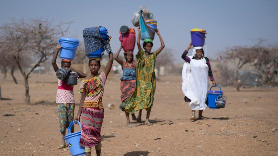 Malian refugees collect aid items at Goudoubo camp, Burkina Faso, February 2020.