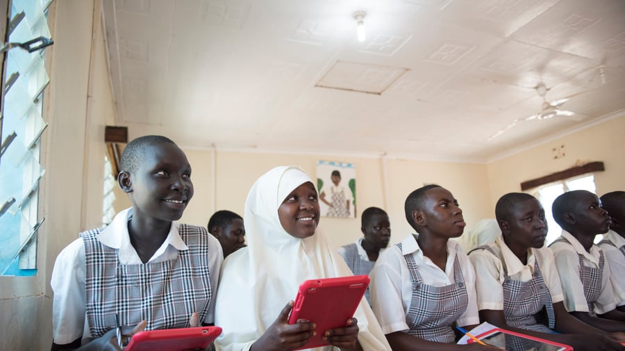 A group of students in a classroom using tablets