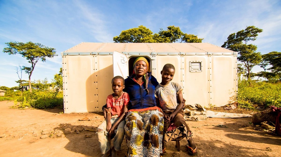 Burundian refugee Velarie Ntahonicaye and her family pose outside their home in Kigoma Refugee Camp, Tanzania, April 2019.