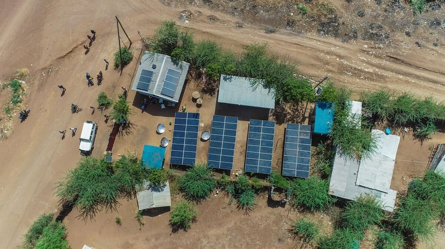Birds-eye view of solar panels that provide energy to refugee businesses and homes in Kakuma Refugee Camp.